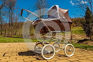 Retro style baby carriage outdoors on sunny day