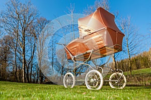 Retro style baby carriage outdoors on sunny day