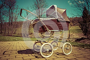 Retro style baby carriage outdoors on sunny day