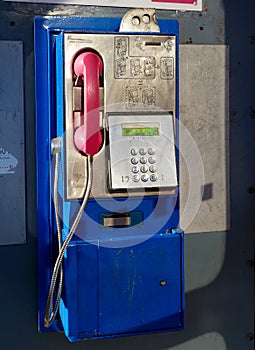 Retro style blue and pink land line public telephone