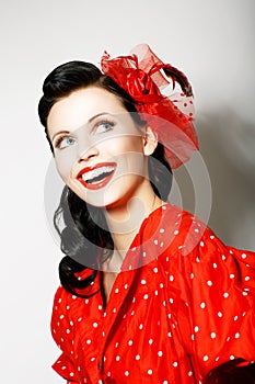 Retro Style. Elation. Portrait of Happy Toothy Smiling Woman in Pin Up Red Dress