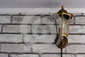 Retro style electric lantern on brick wall