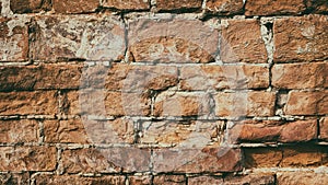 Retro style grunge background of old crumbled orange brick wall