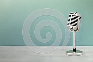 Retro style microphone isolated on green background