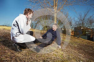 Retro style paramedic helping wounded man in city park