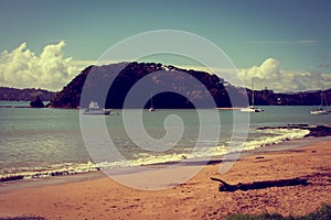 Retro style photo of a summer day in Paihia, Bay of Islands. Leisure boats anchored by the beach. Northland, New Zealand