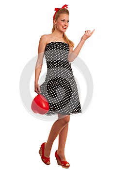 Retro style pin up girl with blonde hair in black dress wtih whi