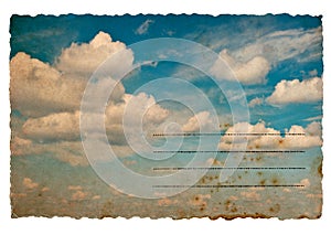 Retro style postcard with cloudy blue sky background