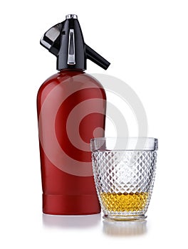 A retro style red soda siphon, and a glass of whisky, isolated on white