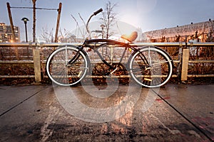 Retro style vintage bicycle locked by the fence on city street in the old town