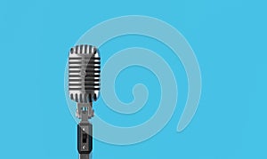 Retro style vintage microphone on blue background