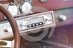 Retro Styled Image Of An Old Car Radio and Vintage Porsche steering wheel