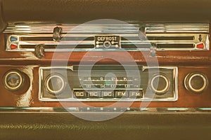 Retro styled image of an old dashboard with seventies car radio