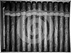Retro styled photo of large box of Cuban cigars on a wooden tabl