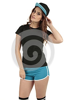 Retro styled sports model wearing a blank black t-shirt and blue running shorts teamed up with a baseball cap
