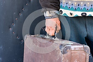 Retro suitcase in a man`s hand