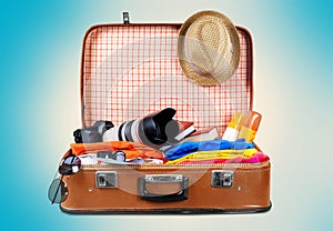 Retro suitcase with travel objects on background