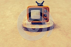 Retro syled tiny television model on brown