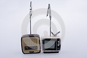 Retro syled tiny television and radio model on white background