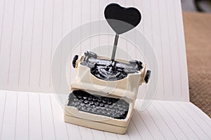 Retro syled tiny typewriter model on paper