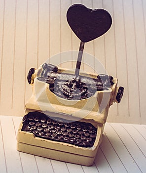 Retro syled tiny typewriter model on paper