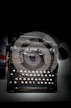 Retro syled tiny typewriter model on white background