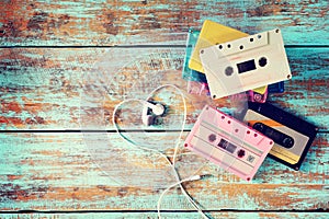 Retro tape cassette with earphone heart shape on wood table. photo