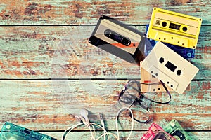 Retro tape cassette with earphone on wood table