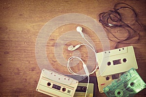 retro tape cassette with earphone on wood table photo