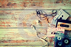 Retro tape cassette with earphone on wood table photo