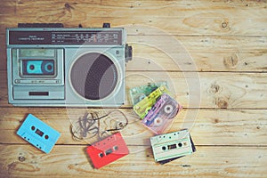 Retro technology of radio cassette recorder music with retro tape cassette on wood table