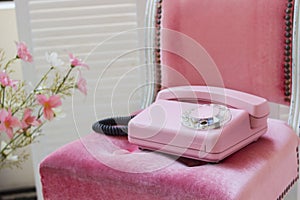 Old pink home phone. Wired vintage phone. Retro