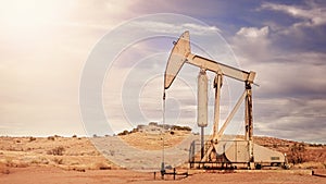 Retro toned panoramic picture of old oil pump.