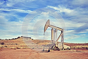 Retro toned picture of an old oil pump.