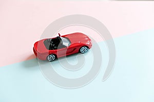 Retro toy car detail. Red toy car with an open top on a white background. convertible toy, the concept of renting a car