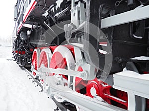 Retro train. Locomotive of the 19th early 20th century with a steam engine. Vintage style. Black train with red wheels. Metal cast