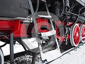 Retro train. Locomotive of the 19th early 20th century with a steam engine. Vintage style. Black train with red wheels. Metal cast