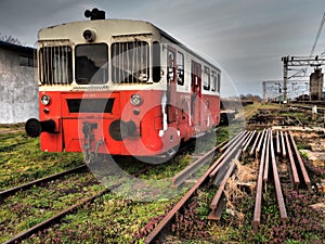 Retro train wagon of red color. Vintage locomotive made in Yugoslavia. Sremska Mitrovica, Serbia. The metal body of a