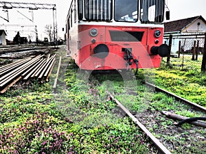 Retro train wagon of red color. Vintage locomotive made in Yugoslavia. Sremska Mitrovica, Serbia. The metal body of a