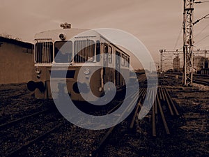 Retro train wagon. Vintage locomotive made in Yugoslavia. Sremska Mitrovica, Serbia. Sepia. The metal body of a railway