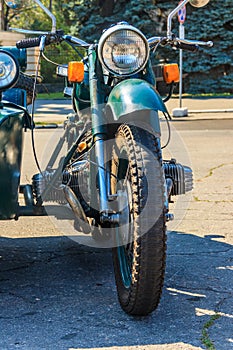 Retro tricar. Three-wheeled motorcycle on city street