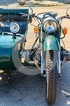 Retro tricar. Three-wheeled motorcycle on city street