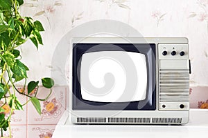 Retro TV in a white screen room with vintage wallpaper in the style of the 1980s 1990s.