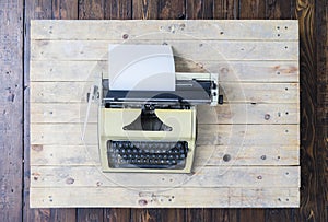 Retro typewriter on a vintage wooden background