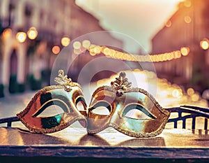 Retro Venetian carnival masks in front of canal in Venice