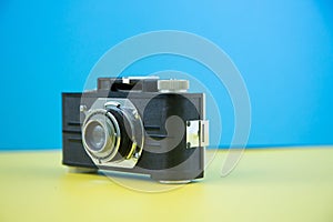 A retro vintage camera shot on a colorful background