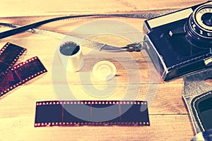 Retro vintage camera on wooden background.