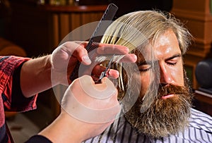 Retro and vintage. Designing haircut. barber tools in barbershop. handsome hairdresser cutting hair of male client