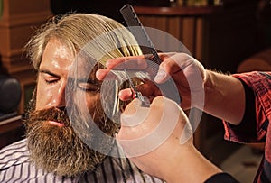 Retro and vintage. Designing haircut. barber tools in barbershop. handsome hairdresser cutting hair of male client