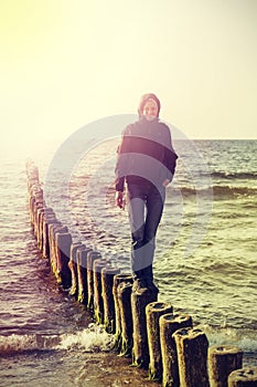 Retro vintage filtered picture of happy girl on the beach